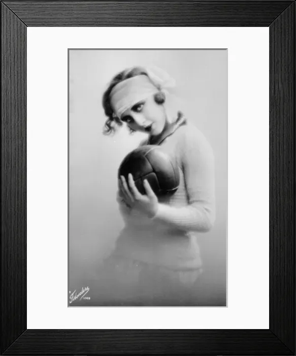Framed Print : Young woman holding a football Framed Print : Young woman holding a football