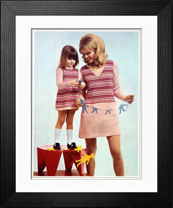 Framed Print : Mother and daughter in matching knitted outfits Framed Print : Mother and daughter in matching knitted outfits