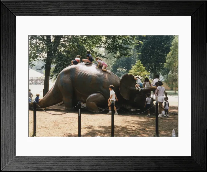 Framed Print : Children playing on a Dinosaur Model Framed Print : Children playing on a Dinosaur Model