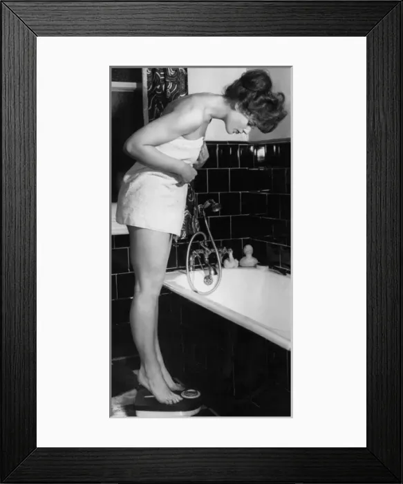 Framed Print : Girl Weighs Herself Framed Print : Girl Weighs Herself