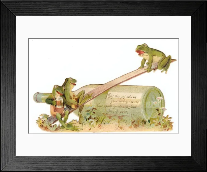 Framed Print : Three frogs seesawing on a cutout Christmas card Framed Print : Three frogs seesawing on a cutout Christmas card