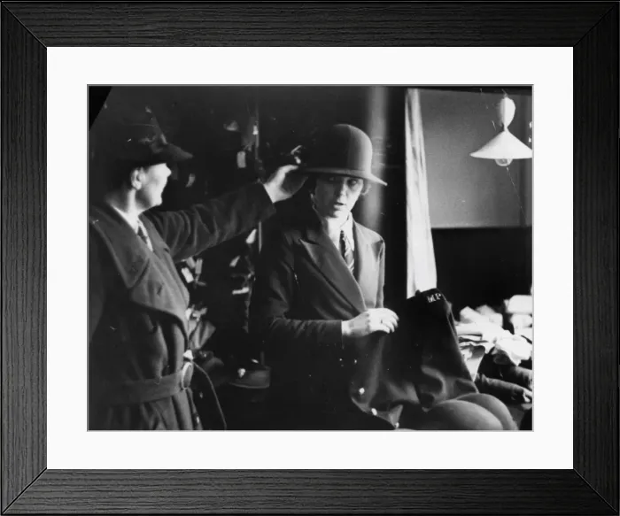 Framed Print : Woman being fitted with policewomans uniform Framed Print : Woman being fitted with policewomans uniform