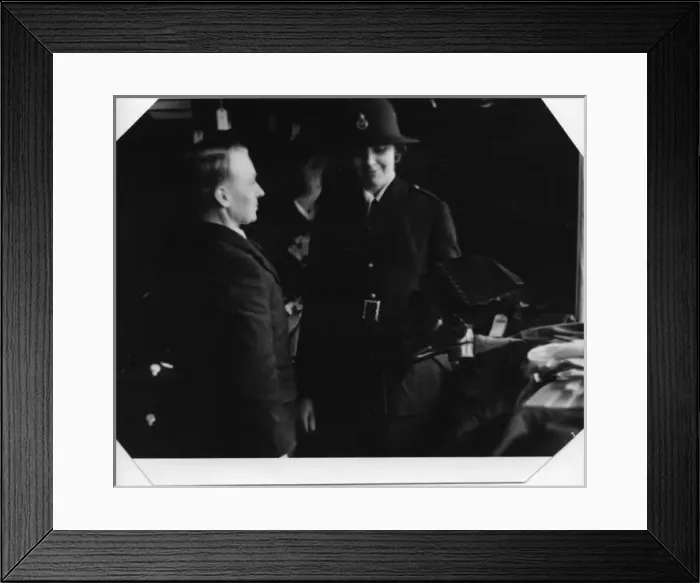 Framed Print : Woman being fitted with policewomans uniform Framed Print : Woman being fitted with policewomans uniform
