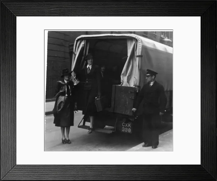 Framed Print : Woman stepping out of the back of a covered van Framed Print : Woman stepping out of the back of a covered van