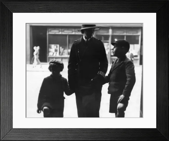 Framed Print : Woman police officer holding hands with children, London Framed Print : Woman police officer holding hands with children, London