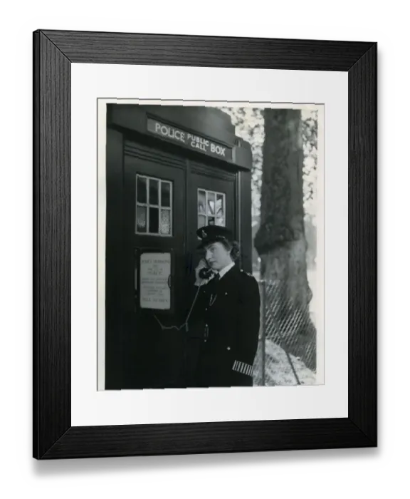 Framed Print : Woman police officer on telephone in a London street Framed Print : Woman police officer on telephone in a London street