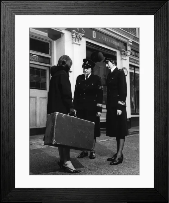 Framed Print : Two women police officers and woman with suitcase Framed Print : Two women police officers and woman with suitcase