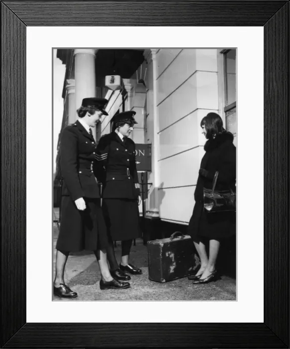 Framed Print : Two women police officers and woman with suitcase Framed Print : Two women police officers and woman with suitcase