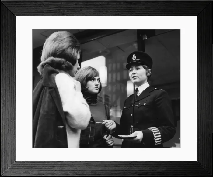 Framed Print : Woman police officer and two young women, London Framed Print : Woman police officer and two young women, London