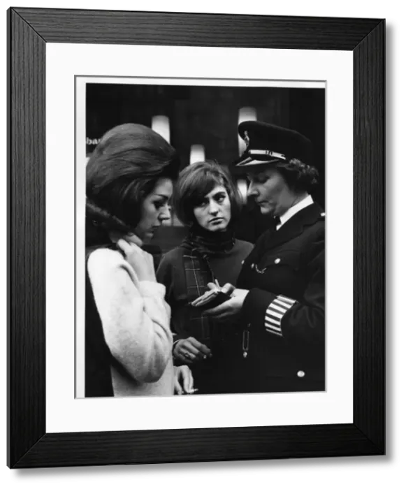Framed Print : Woman police officer and two young women, London Framed Print : Woman police officer and two young women, London