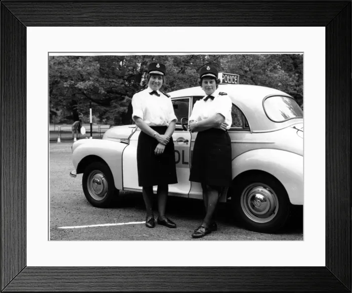 Framed Print : Two women police officers standing by a car, London Framed Print : Two women police officers standing by a car, London