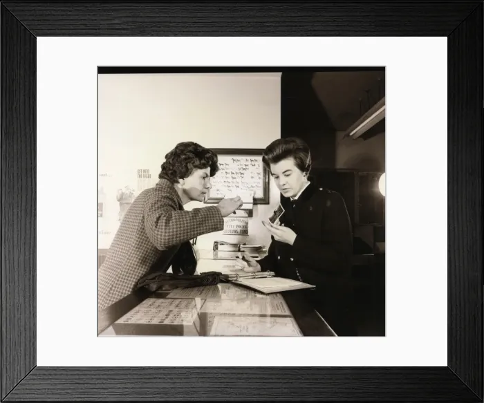 Framed Print : Woman police officer working at a police station Framed Print : Woman police officer working at a police station