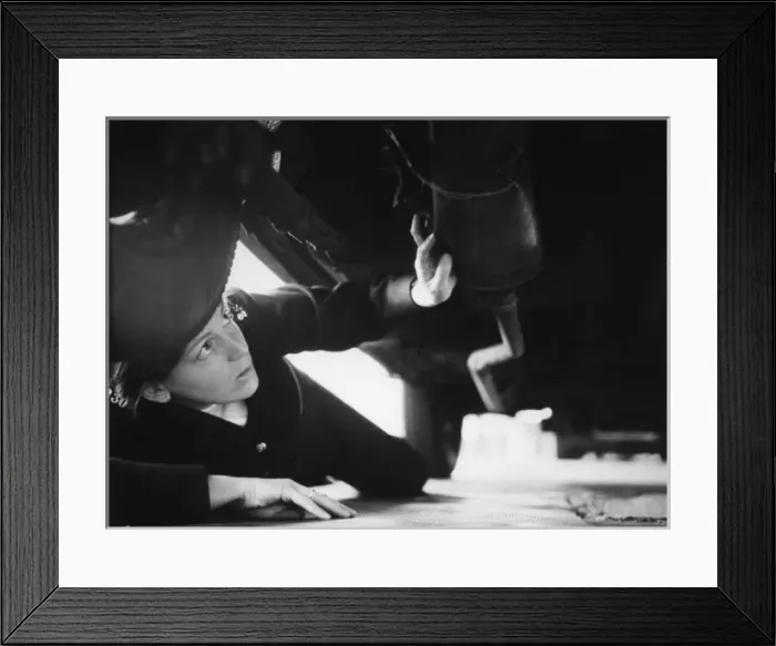 Framed Print : Woman police officer checking under a car, London Framed Print : Woman police officer checking under a car, London