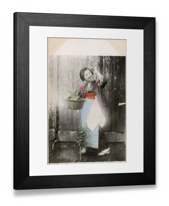 Framed Print : Happy Japanese woman doing a spot of gardening Framed Print : Happy Japanese woman doing a spot of gardening