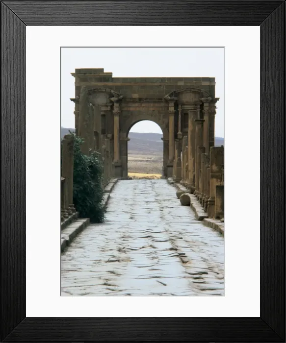 Framed Print : Algeria. Timgad. Roman causeway and Trajans Arch Framed Print : Algeria. Timgad. Roman causeway and Trajans Arch