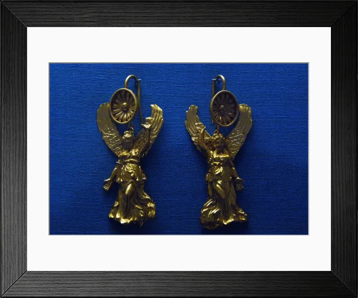 Framed Print : Golden earrings with shaped like a Nike Framed Print : Golden earrings with shaped like a Nike