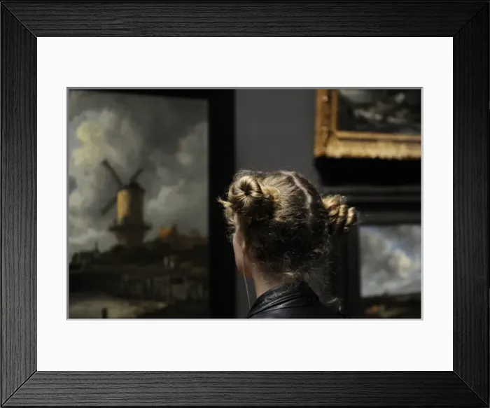 Framed Print : Young woman looking the painting The Windmill at Wijk bij Du Framed Print : Young woman looking the painting The Windmill at Wijk bij Du
