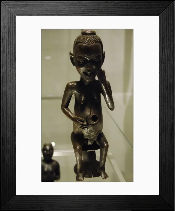 Framed Print : Africa. Pipe in the form of a seated female figure. Made of Framed Print : Africa. Pipe in the form of a seated female figure. Made of