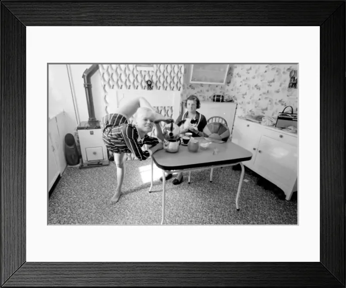 Framed Print : Female contortionist Diana Gaye making tea Framed Print : Female contortionist Diana Gaye making tea