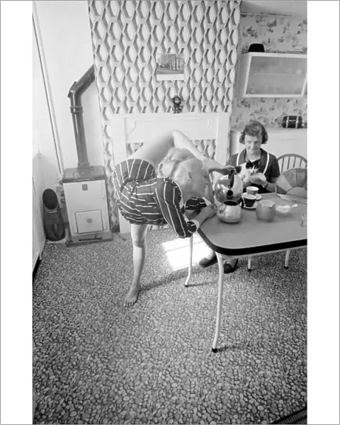 Female contortionist Diana Gaye making tea