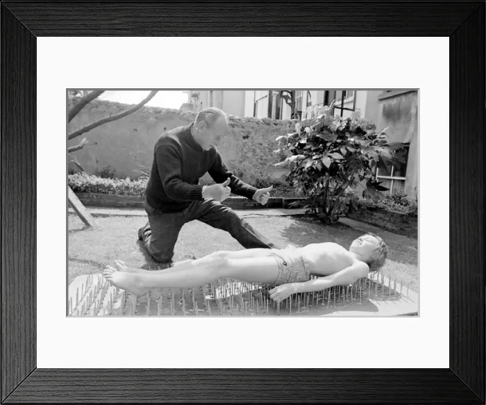 Framed Print : Boy stuntman on bed of nails Framed Print : Boy stuntman on bed of nails