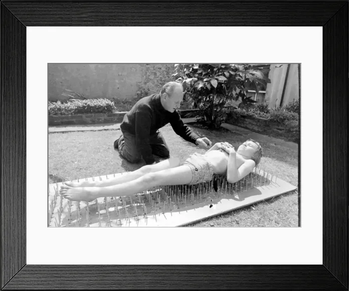 Framed Print : Boy stuntman on bed of nails Framed Print : Boy stuntman on bed of nails