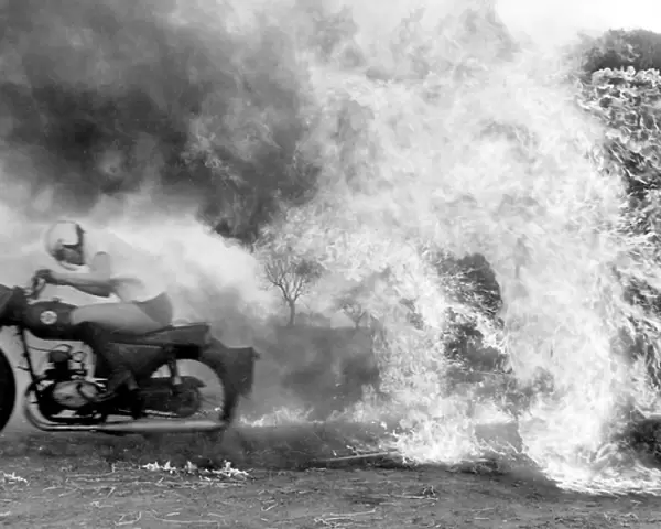 Stunt woman rides through flames on motorbike