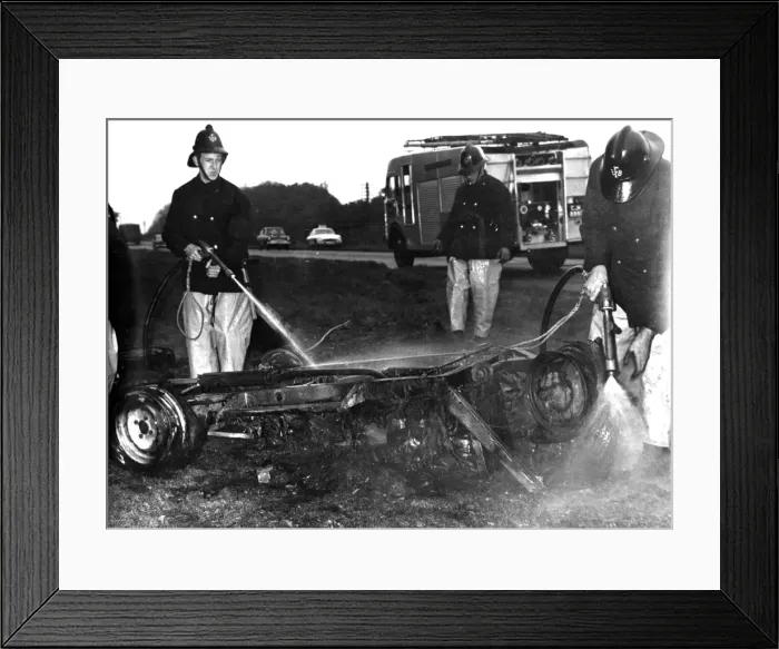 Framed Print : Firefighters hosing down a burnt-out car Framed Print : Firefighters hosing down a burnt-out car