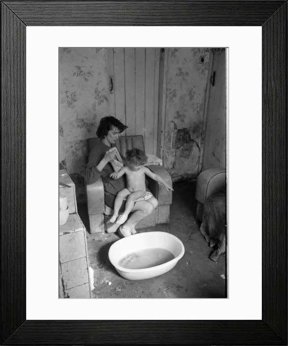 Framed Print : Woman bathing baby, Falls Road, Northern Ireland Framed Print : Woman bathing baby, Falls Road, Northern Ireland