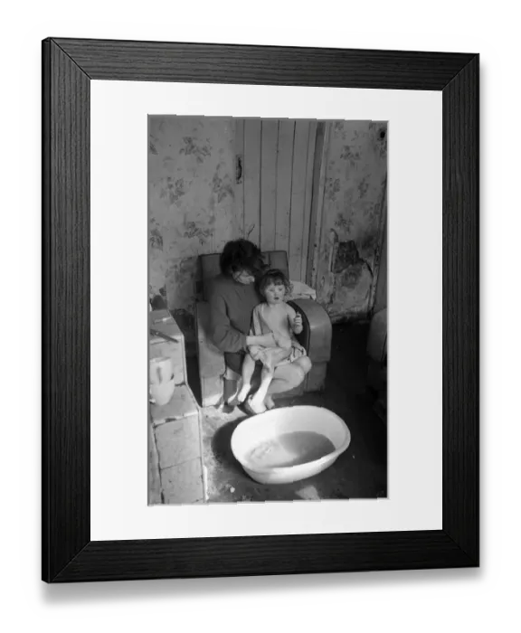 Framed Print : Woman bathing baby, Falls Road, Northern Ireland Framed Print : Woman bathing baby, Falls Road, Northern Ireland