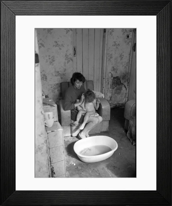 Framed Print : Woman bathing baby, Falls Road, Northern Ireland Framed Print : Woman bathing baby, Falls Road, Northern Ireland