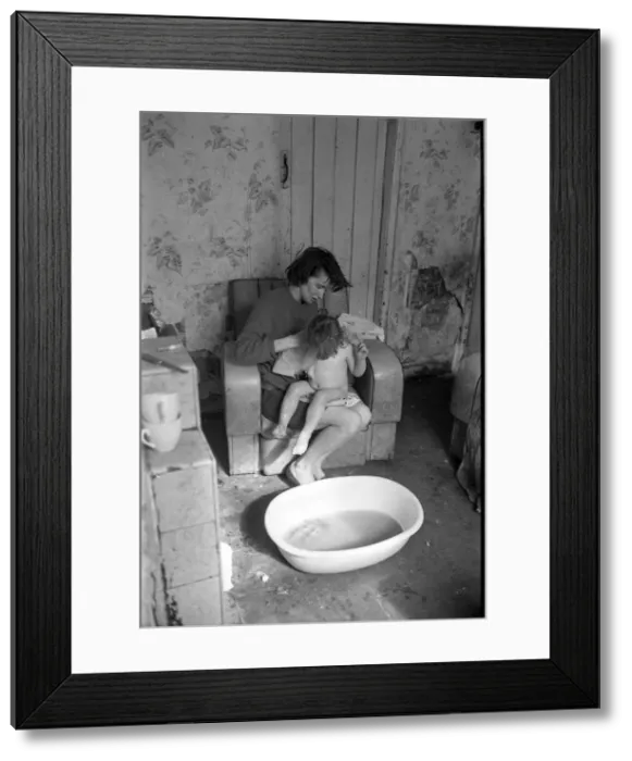 Framed Print : Woman bathing baby, Falls Road, Northern Ireland Framed Print : Woman bathing baby, Falls Road, Northern Ireland