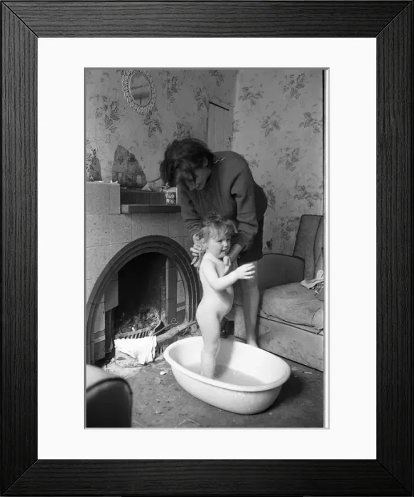 Framed Print : Woman bathing baby, Falls Road, Northern Ireland Framed Print : Woman bathing baby, Falls Road, Northern Ireland