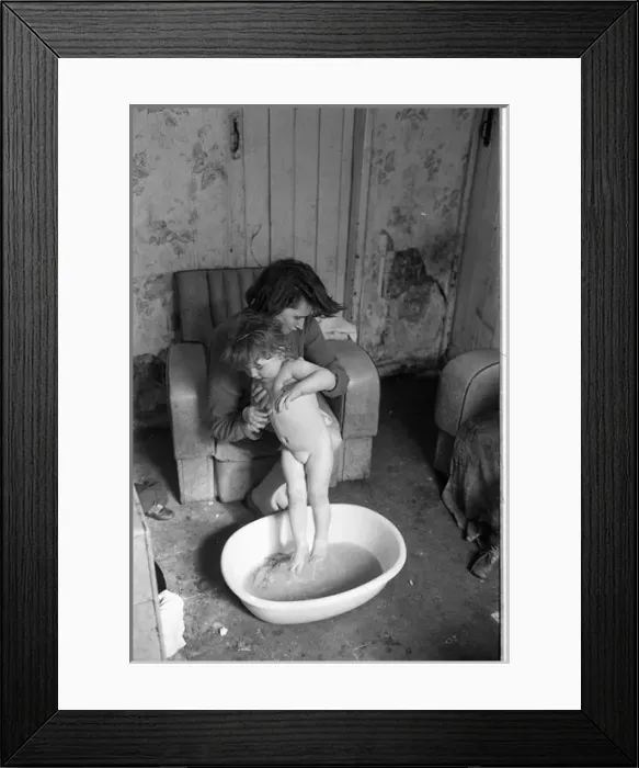 Framed Print : Woman bathing baby, Falls Road, Northern Ireland Framed Print : Woman bathing baby, Falls Road, Northern Ireland