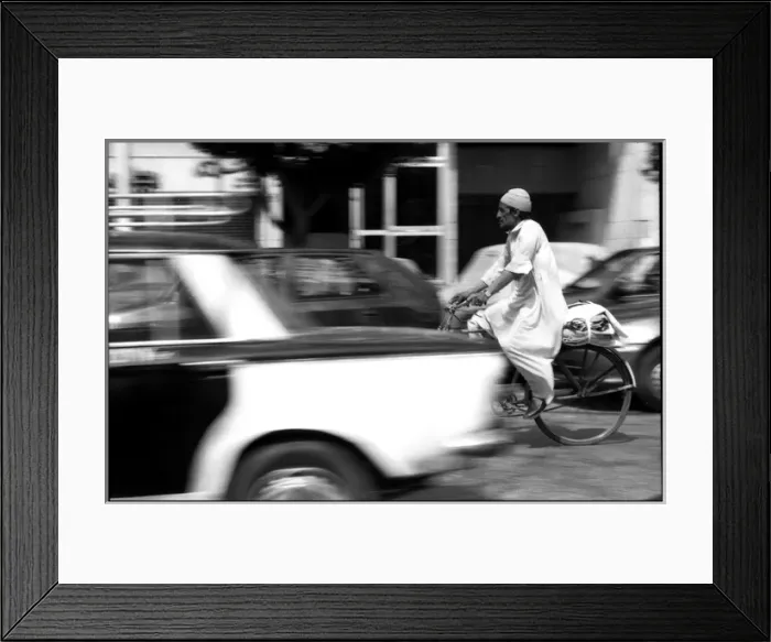 Framed Print : Man on bike in Cairo traffic, Egypt Framed Print : Man on bike in Cairo traffic, Egypt