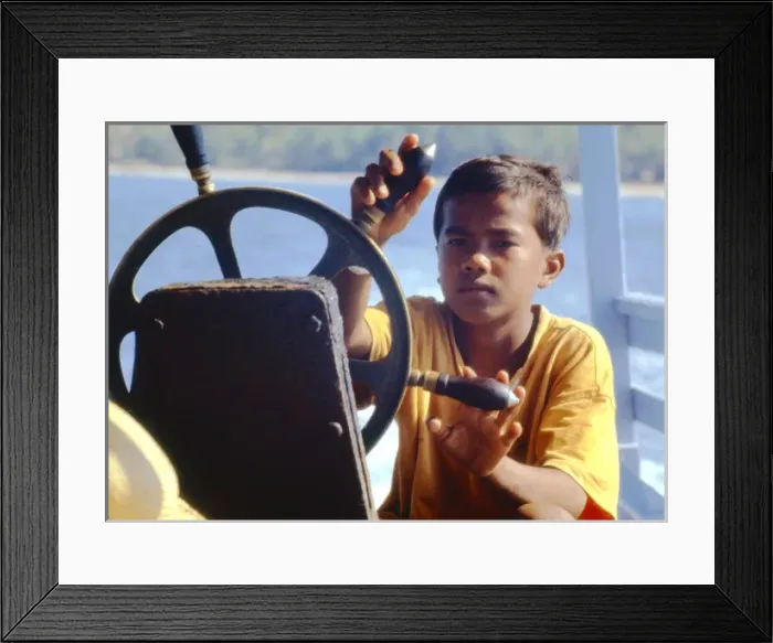 Framed Print : Boy steering a boat, Thailand Framed Print : Boy steering a boat, Thailand
