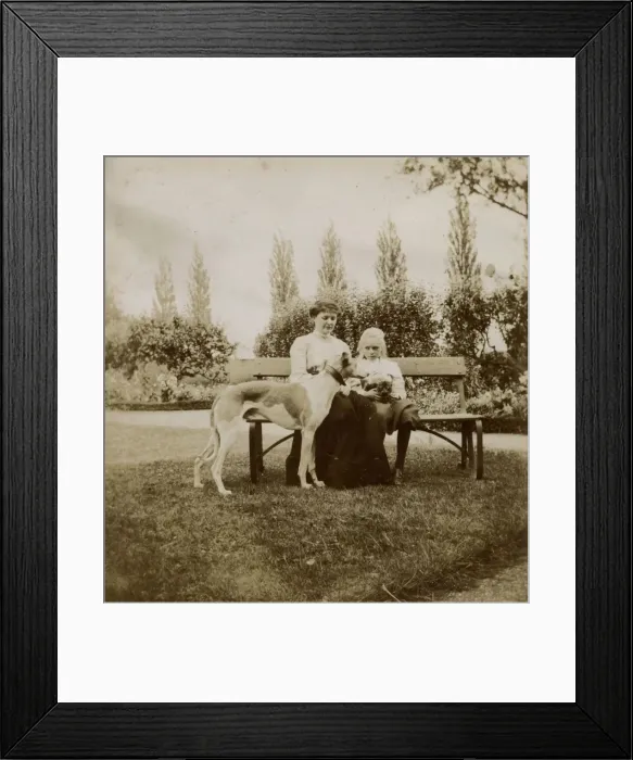 Framed Print : Woman and girl with dog and cat on a garden bench Framed Print : Woman and girl with dog and cat on a garden bench