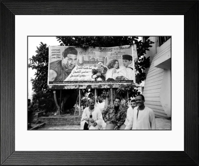 Framed Print : Group of men and film poster Alexandria, Egypt Framed Print : Group of men and film poster Alexandria, Egypt