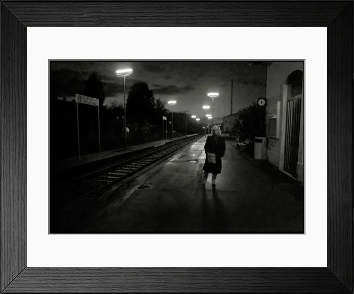 Framed Print : Woman on railway station platform late evening, Italy Framed Print : Woman on railway station platform late evening, Italy
