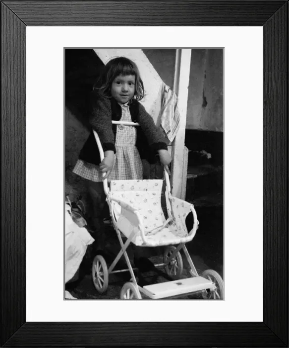 Framed Print : Little girl with pushchair on stairs interior Framed Print : Little girl with pushchair on stairs interior