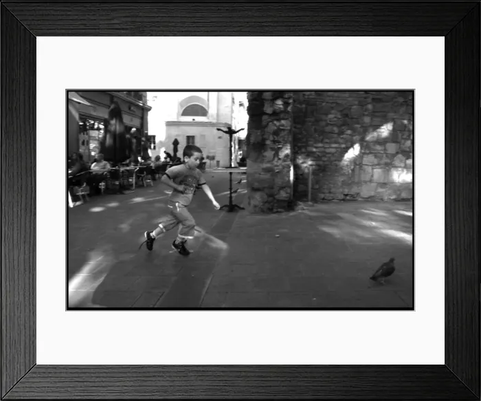 Framed Print : Boy chasing a pigeon Avignon France Framed Print : Boy chasing a pigeon Avignon France