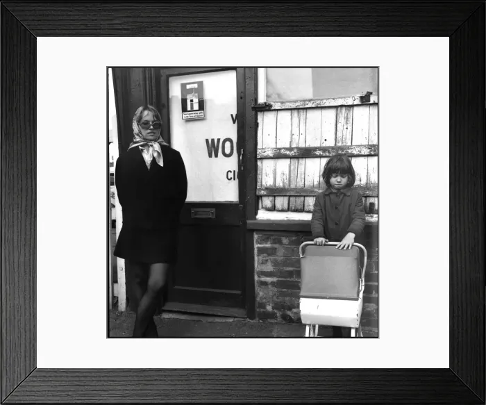 Framed Print : Trendy young mum with daughter and toy pram early Framed Print : Trendy young mum with daughter and toy pram early