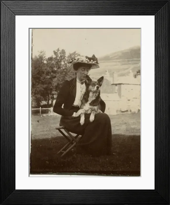 Framed Print : Woman with dog in a garden Framed Print : Woman with dog in a garden