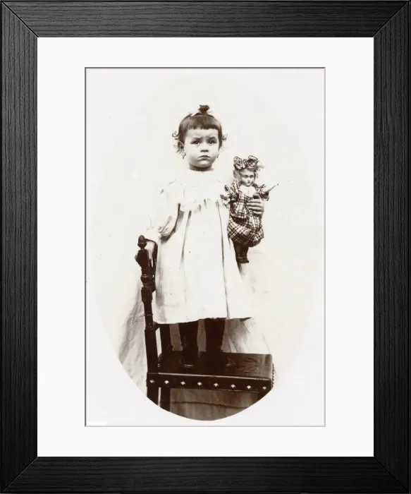 Framed Print : Little girl with doll, Normandy, France Framed Print : Little girl with doll, Normandy, France