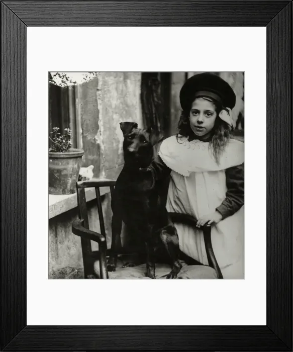 Framed Print : Girl with dog outside a house Framed Print : Girl with dog outside a house