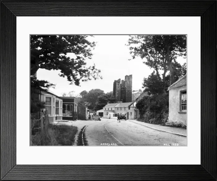 Framed Print : Ardglass - a view up a street to the Castle, on the road is a motor car and man Framed Print : Ardglass - a view up a street to the Castle, on the road is a motor car and man