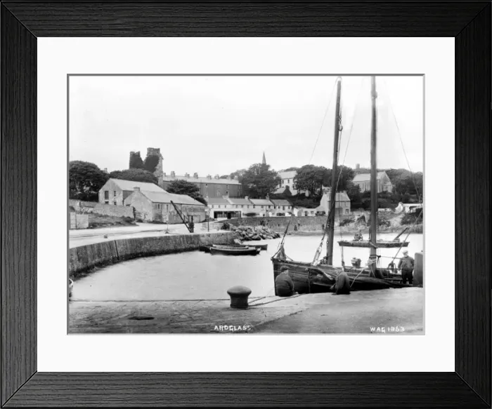 Framed Print : Ardglass - a view from the pier with boat in the foreground to the town beyond Framed Print : Ardglass - a view from the pier with boat in the foreground to the town beyond