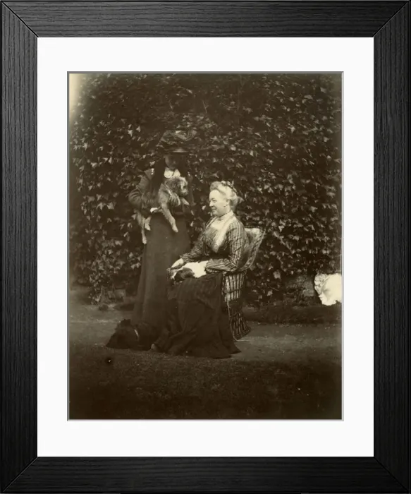 Framed Print : Two women with two dogs in a garden Framed Print : Two women with two dogs in a garden