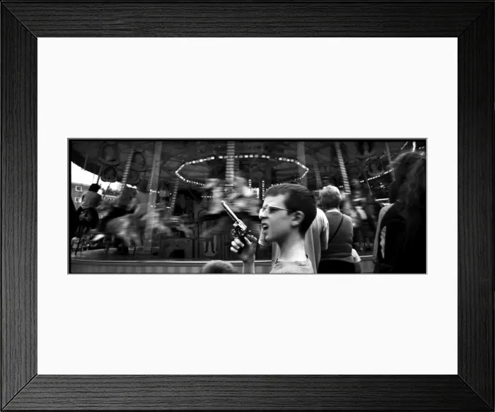 Framed Print : Boy with toy gun at a fairground, London, England Framed Print : Boy with toy gun at a fairground, London, England