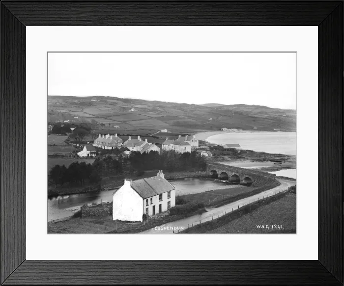 Framed Print : Cushendun - an elevated view of the river and bridge and buildings around Framed Print : Cushendun - an elevated view of the river and bridge and buildings around